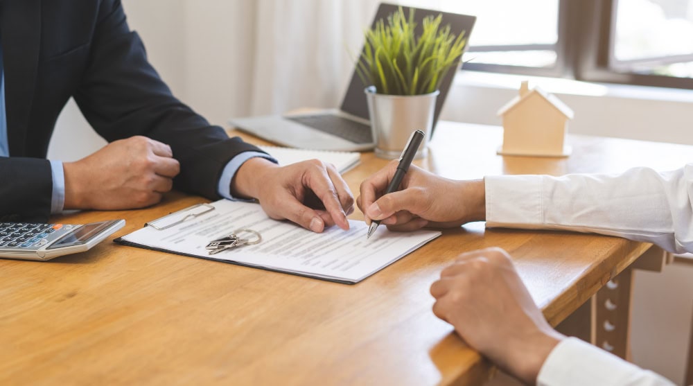 realtor pointing to contract for signature